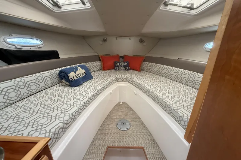 Slide: The Image of 2022 Cutwater C-24 Coupe cabin interior with patterned cushions and decorative pillows. - 46