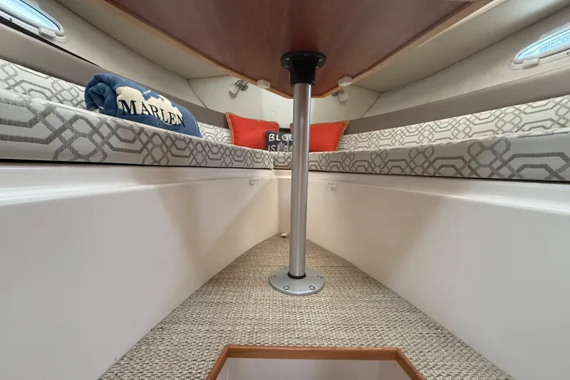 Slide: The Image of Interior of 2022 Cutwater C-24 Coupe with cozy seating and decorative pillows. - 52