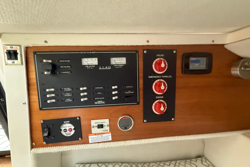 Slide: The Image of Electrical control panel of 2022 Cutwater C-24 Coupe boat, featuring switches and gauges. - 59