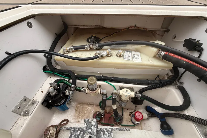 Slide: The Image of Engine compartment of a 2022 Cutwater C-24 Coupe boat, showing fuel and water systems. - 61