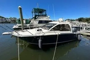 Slide: The Image of 2022 Cutwater C-24 Coupe docked, surrounded by houses. - 7