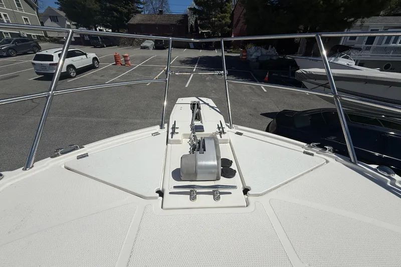 Slide: The Image of 2022 Cutwater C-24 Coupe boat deck with anchor system in a parking lot. - 70