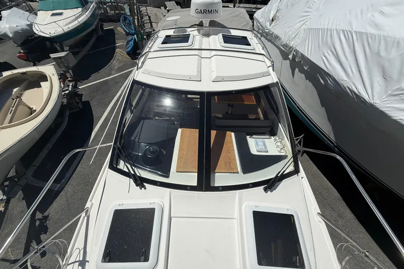 Slide: The Image of 2022 Cutwater C-24 Coupe boat with Garmin equipment, docked among other vessels. - 71