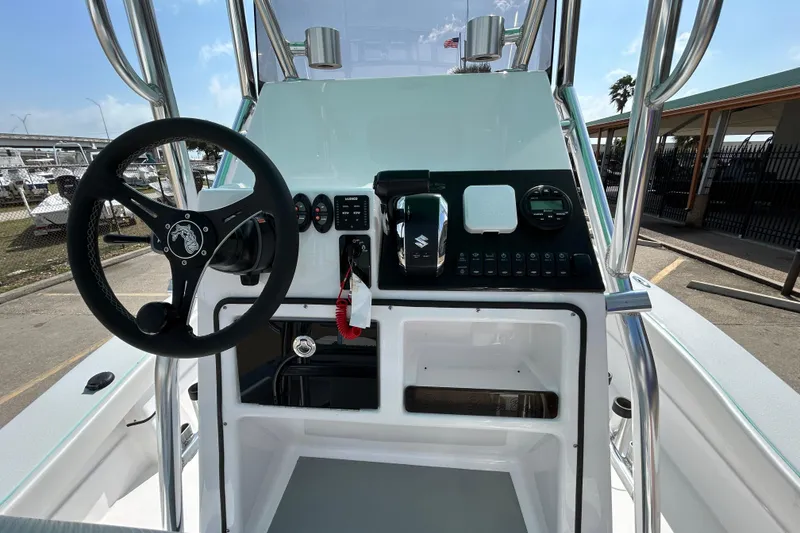 Slide: The Image of 2026 Shallow Stalker The Boss boat dashboard with steering wheel and controls. - 14