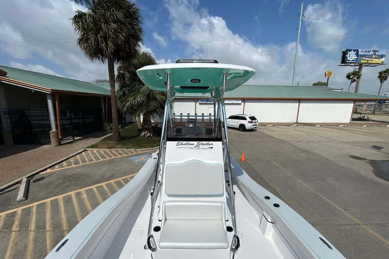 Slide: The Image of Shallow Stalker "The Boss" 2026 boat in a parking lot with palm trees and blue sky. - 19