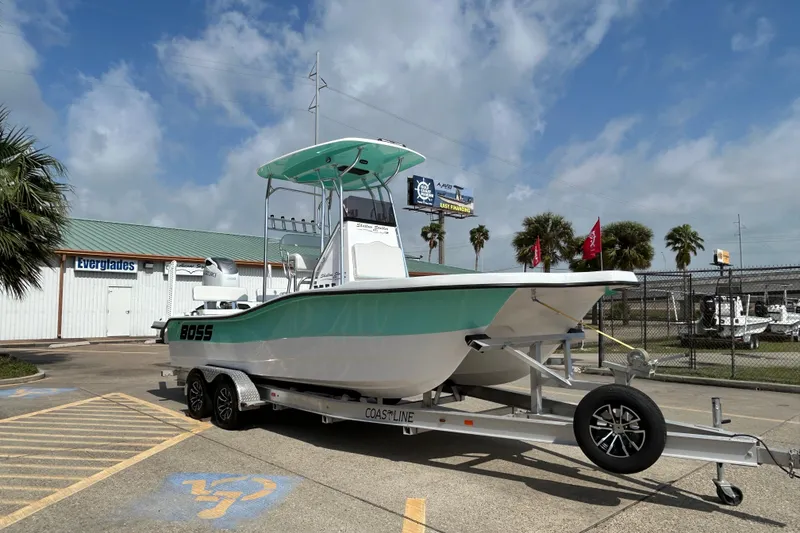Slide: The Image of 2026 Shallow Stalker "The Boss" boat on trailer, parked outdoors under a cloudy sky. - 3