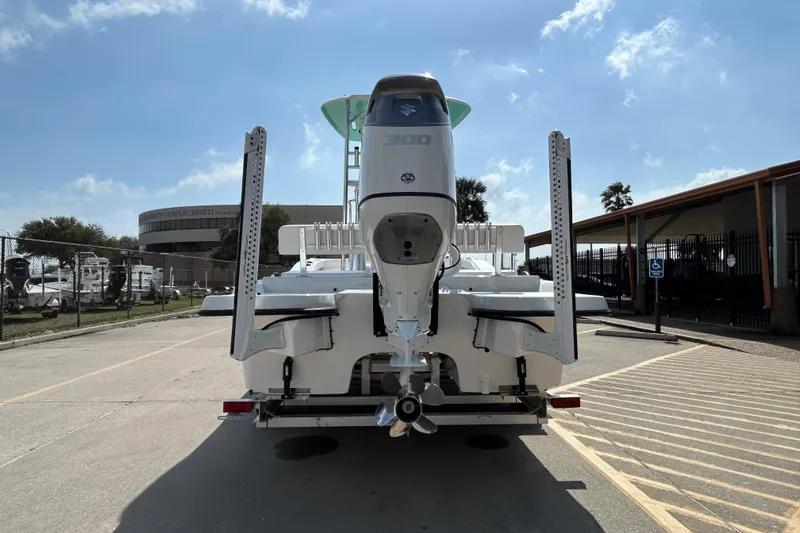 Slide: The Image of 2026 Shallow Stalker The Boss boat with powerful engine, parked outdoors under clear sky. - 6