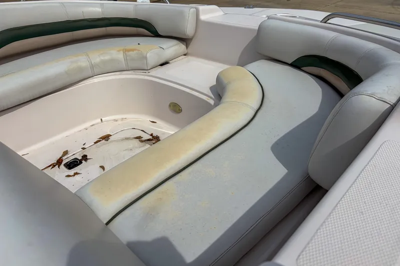 Slide: The Image of 2003 Hurricane FunDeck GS 188 OB boat interior with worn seating and debris. - 10
