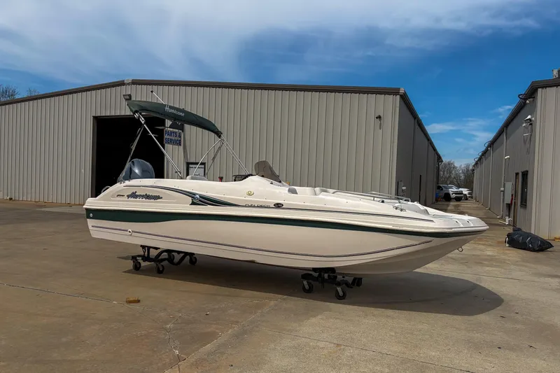 Slide: The Image of 2003 Hurricane FunDeck GS 188 OB boat on display outside service building. - 12