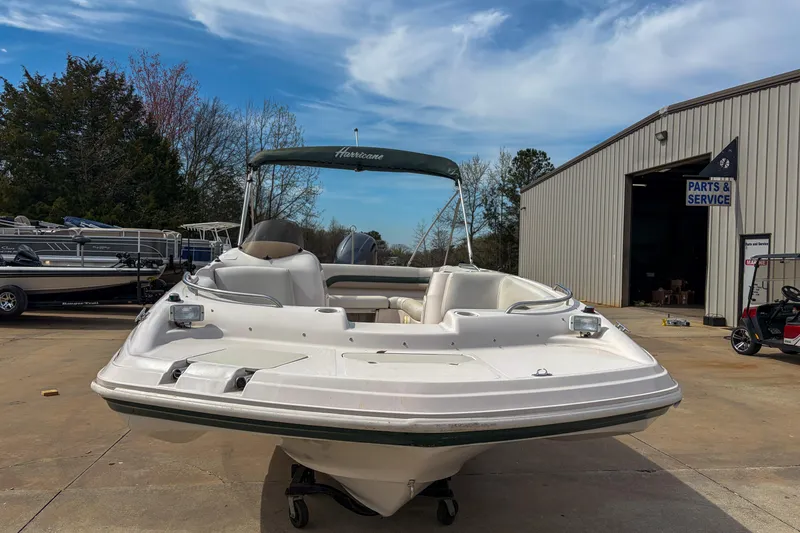 Slide: The Image of 2003 Hurricane FunDeck GS 188 OB boat at service center, clear sky background. - 13