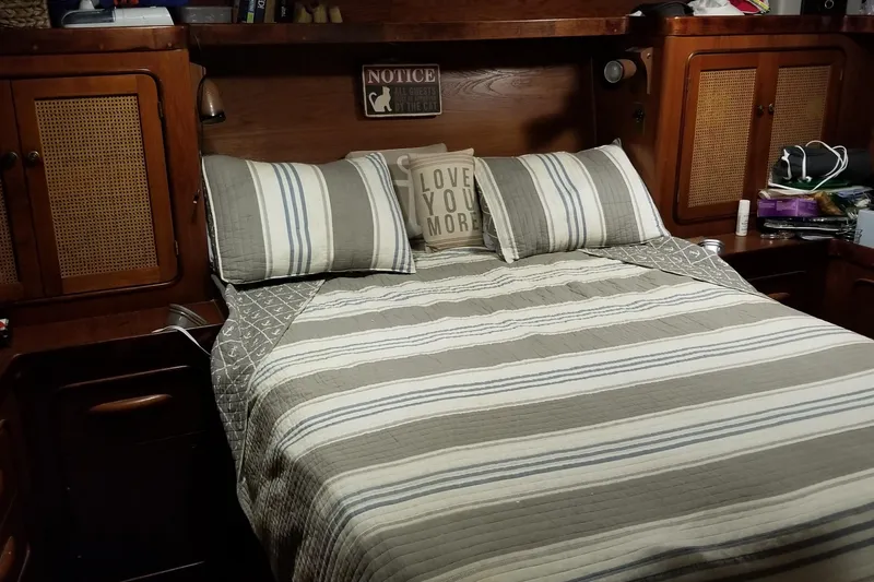 Slide: The Image of Cozy interior of a 1979 Gulfstar 44 boat with sofa, storage, and wooden decor. - 10
