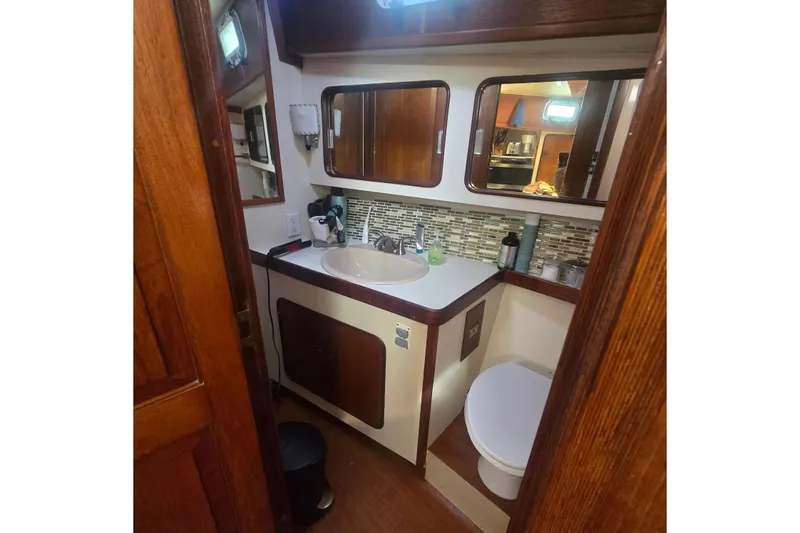 Slide: The Image of Cozy cabin interior of 1979 Gulfstar 44 sailboat with nautical-themed bedding. - 11