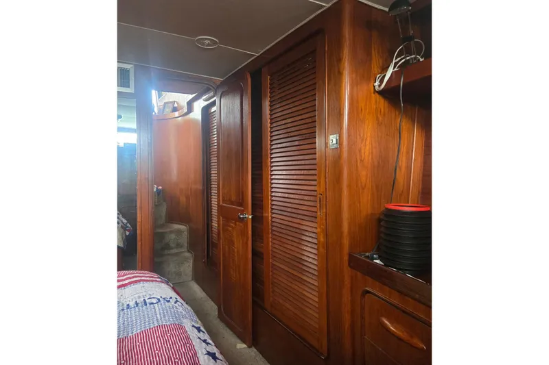 Slide: The Image of Interior of 1979 Gulfstar 44 yacht with wooden cabinetry and decorative items. - 14