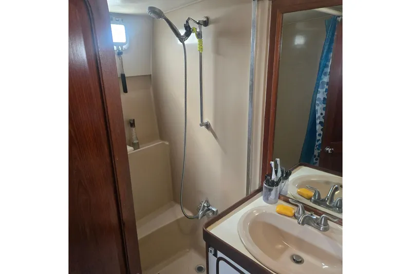 Slide: The Image of Interior of a 1979 Gulfstar 44 boat with cozy seating and wooden decor. - 15