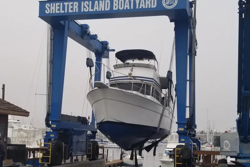 Slide: The Image of 1979 Gulfstar 44 yacht docked in a marina under clear blue skies. - 2