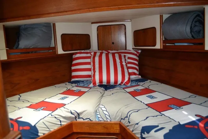 Slide: The Image of Cozy cabin interior of 1979 Gulfstar 44 sailboat with nautical-themed bedding. - 20