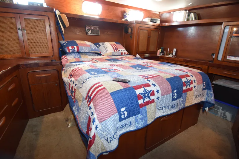 Slide: The Image of Cozy bedroom in a 1979 Gulfstar 44 yacht with nautical-themed quilt. - 24