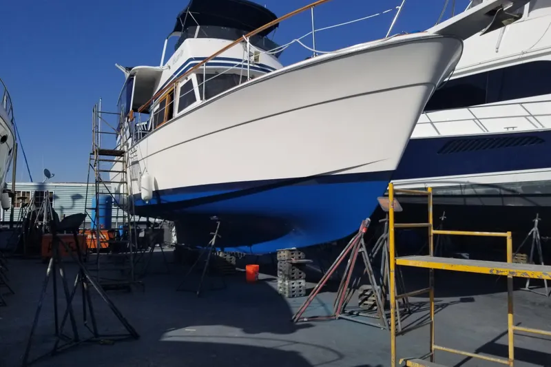 Slide: The Image of 1979 Gulfstar 44 yacht in dry dock, undergoing maintenance with scaffolding. - 37