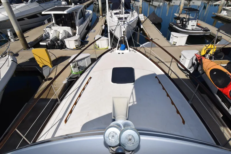 Slide: The Image of 1979 Gulfstar 44 yacht docked at marina, surrounded by other boats. - 38