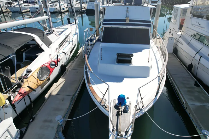 Slide: The Image of 1979 Gulfstar 44 yacht docked at marina, surrounded by other boats. - 39