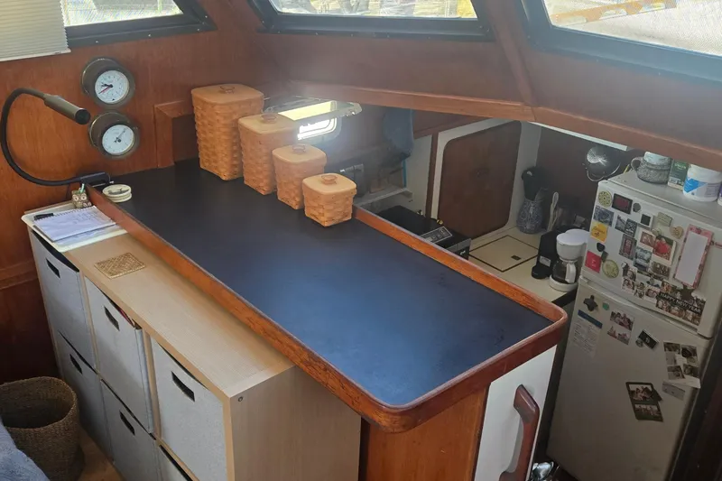Slide: The Image of 1979 Gulfstar 44 yacht helm with steering wheel and cabin interior view. - 4