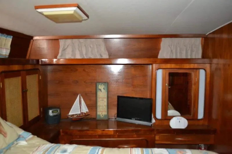 Slide: The Image of Interior of a 1979 Gulfstar 44 boat with cozy seating and wooden decor. - 8
