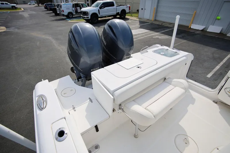 Slide: The Image of 2018 Sea Hunt Gamefish 25 boat with dual Yamaha engines, white seating, and storage area. - 10