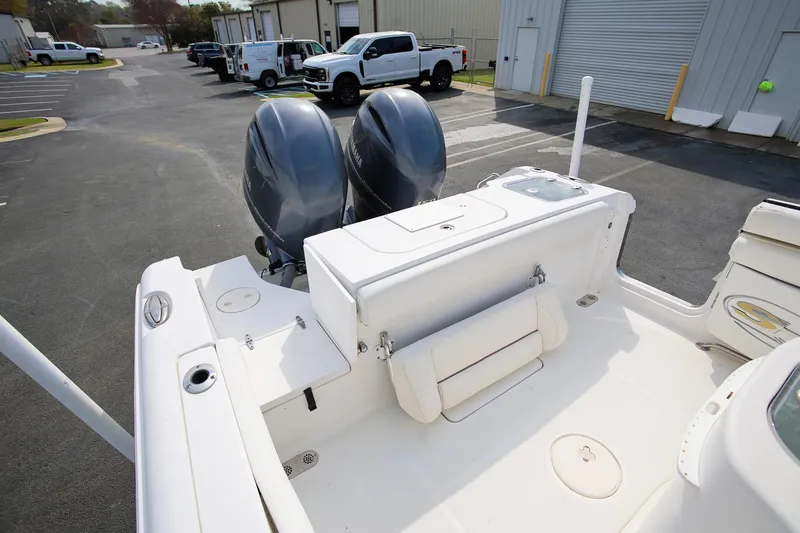 Slide: The Image of 2018 Sea Hunt Gamefish 25 boat with dual outboard engines in a parking lot. - 11