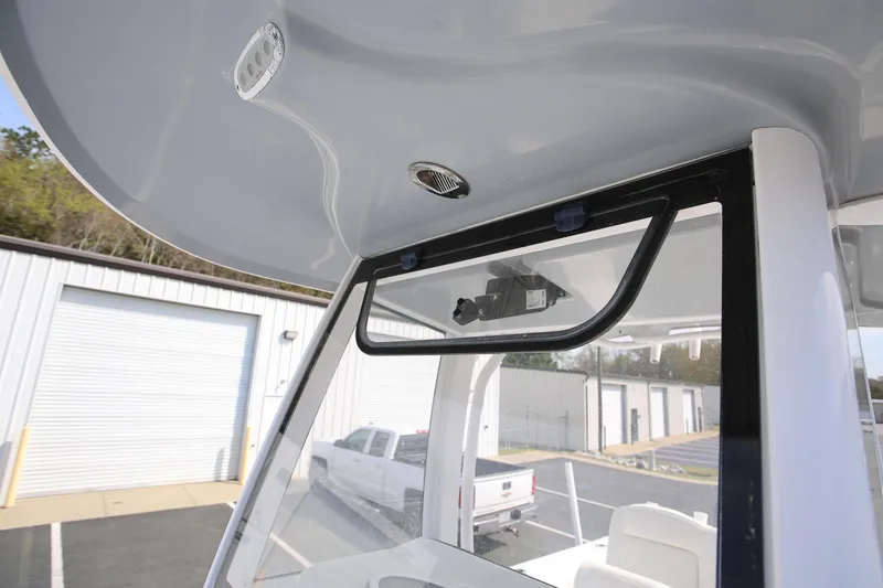 Slide: The Image of 2018 Sea Hunt Gamefish 25 boat interior, featuring console and overhead lighting. - 22