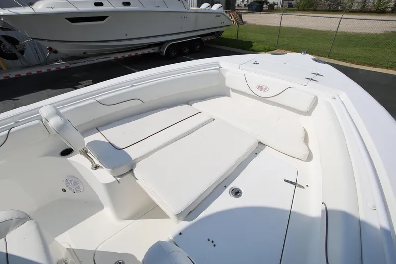 Slide: The Image of 2018 Sea Hunt Gamefish 25 boat interior with white cushioned seating. - 27