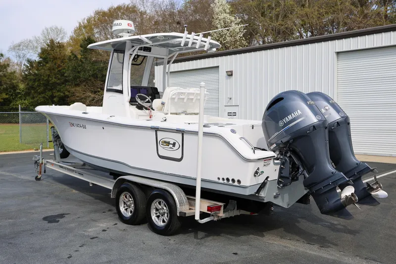 Slide: The Image of 2018 Sea Hunt Gamefish 25 boat with dual Yamaha engines on a trailer. - 3