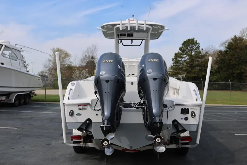 Slide: The Image of 2018 Sea Hunt Gamefish 25 with dual 150 horsepower engines, parked outdoors. - 4