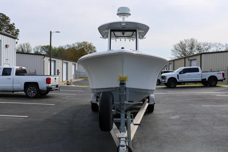 Slide: The Image of 2018 Sea Hunt Gamefish 25 boat on trailer in parking lot with trucks. - 7