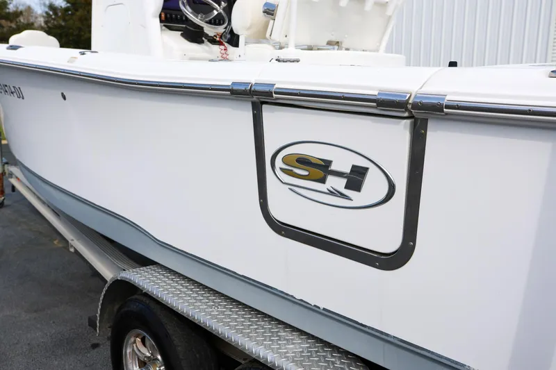 Slide: The Image of 2018 Sea Hunt Gamefish 25 boat on trailer, featuring SH logo. - 8