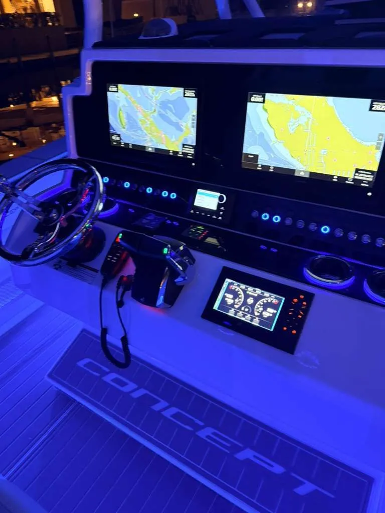 Slide: The Image of Concept 39' Open 2023 helm with navigation screens. - 21