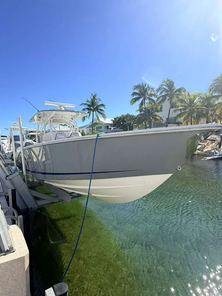 Slide: The Image of 2023 Concept 39' Open boat docked with palm trees in background. - 31