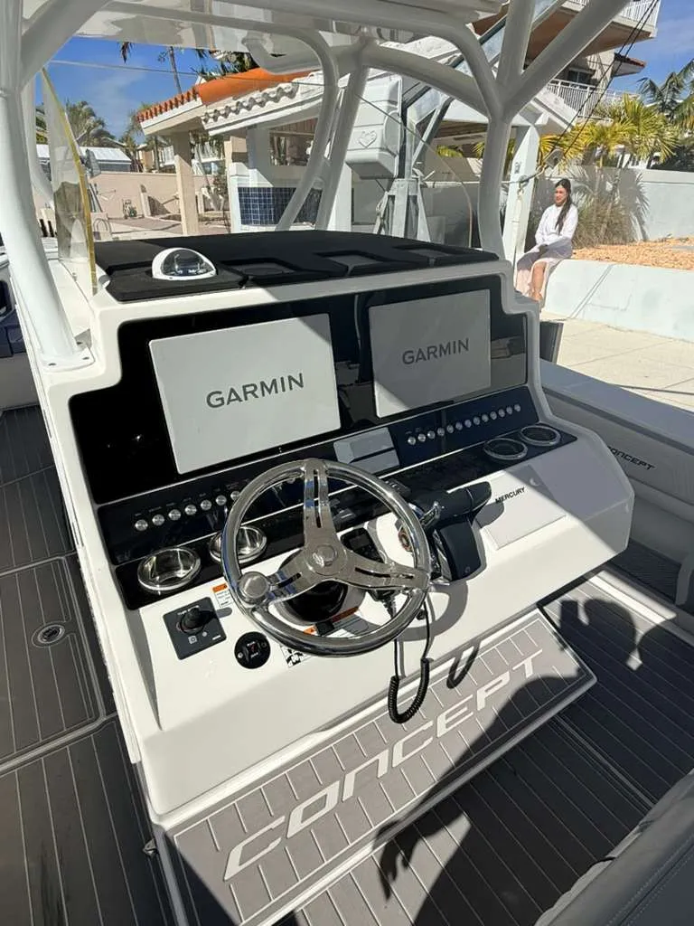 Slide: The Image of Helm of Concept 39' Open boat, 2023 model, featuring Garmin screens. - 8