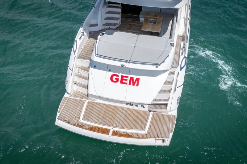 Slide: The Image of Sunseeker 68 Sport Yacht 2014, named "GEM," docked in Miami, FL, viewed from above. - 10