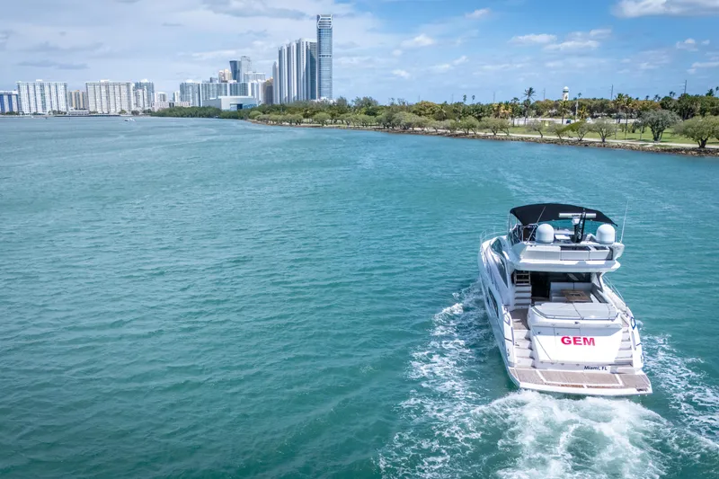 Slide: The Image of 2014 Sunseeker 68 Sport Yacht cruising near city skyline and waterfront. - 11