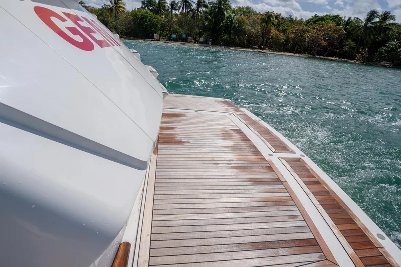 Slide: The Image of Sunseeker 68 Sport Yacht 2014, teak deck, ocean view, tropical backdrop, luxury boating experience. - 13