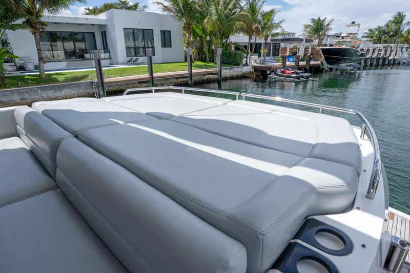 Slide: The Image of Luxurious Sunseeker 68 Sport Yacht 2014 with spacious sunbathing area, docked by waterfront homes. - 21