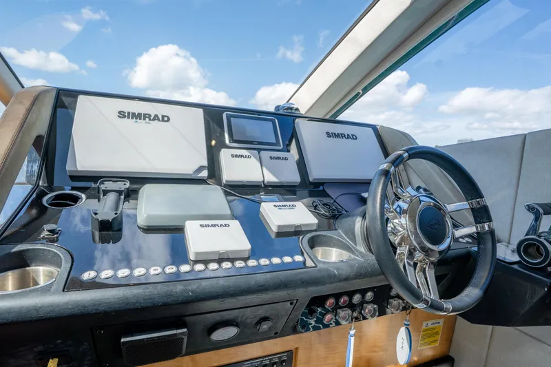 Slide: The Image of Helm of 2014 Sunseeker 68 Sport Yacht with Simrad navigation systems and sleek steering wheel. - 33