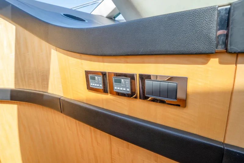 Slide: The Image of Control panel on 2014 Sunseeker 68 Sport Yacht, featuring sleek wood and leather design. - 34