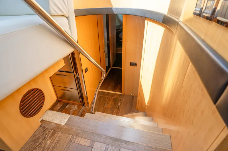 Slide: The Image of Interior staircase of 2014 Sunseeker 68 Sport Yacht, featuring sleek wood and modern design. - 36