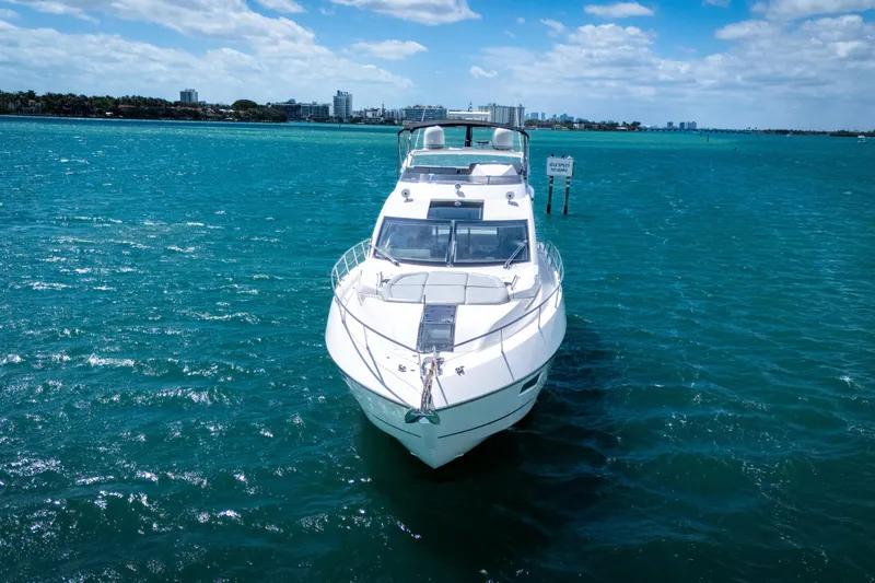 Slide: The Image of 2014 Sunseeker 68 Sport Yacht on vibrant blue water under a partly cloudy sky. - 4