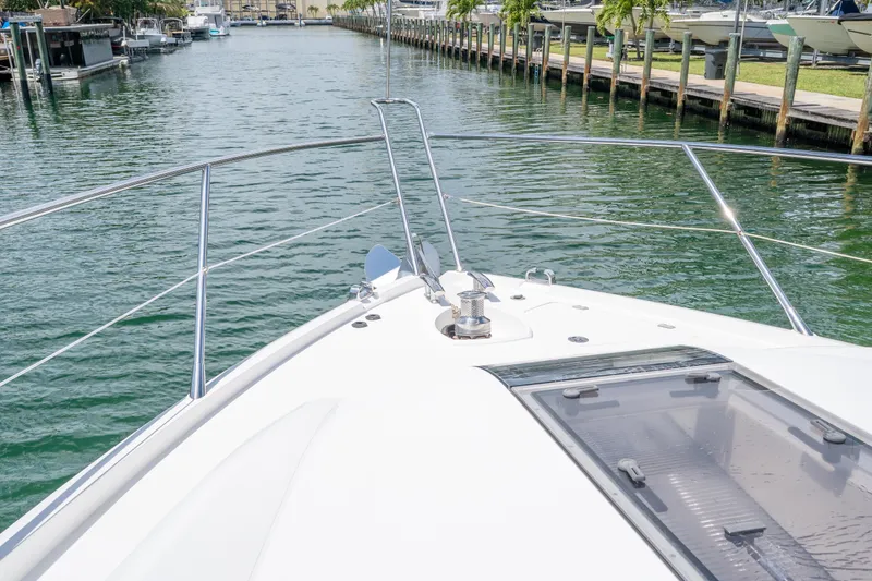 Slide: The Image of Bow view of 2014 Sunseeker 68 Sport Yacht in a marina setting. - 58
