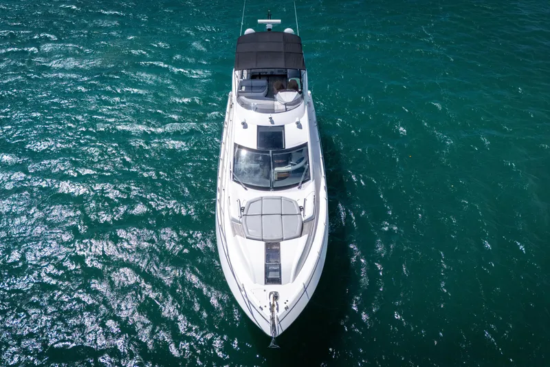 Slide: The Image of Sunseeker 68 Sport Yacht 2014 cruising on clear blue water, aerial view. - 6