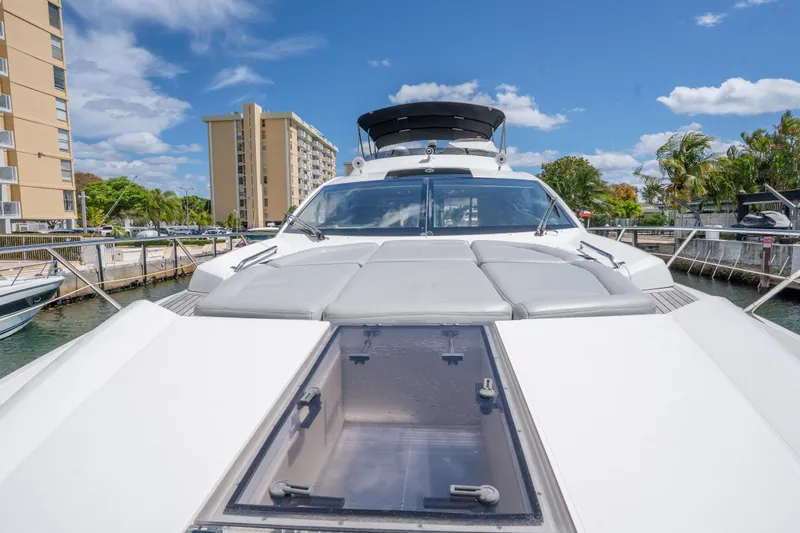 Slide: The Image of 2014 Sunseeker 68 Sport Yacht docked, showcasing sleek design and spacious deck. - 60