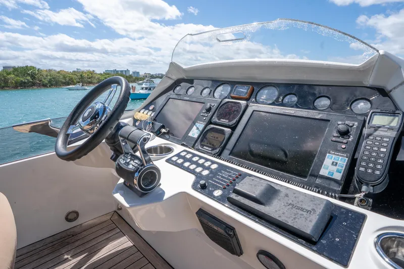Slide: The Image of Cockpit of 2014 Sunseeker 68 Sport Yacht with advanced navigation controls and steering wheel. - 71