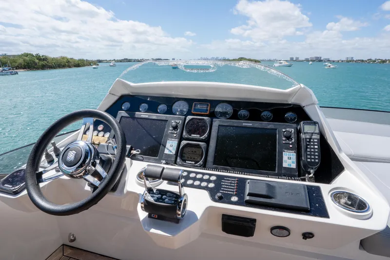 Slide: The Image of Cockpit of 2014 Sunseeker 68 Sport Yacht with steering wheel and navigation controls. - 72